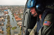 A Jayhawk helicopter crewman assists in search and rescue efforts.