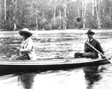 Two people in a wooden canoe on the Wakulla River.