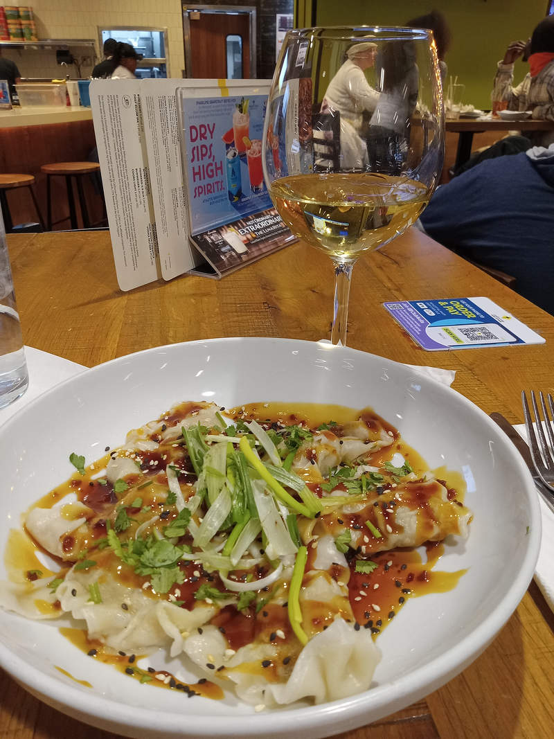 Nine ounce pour of chardonnay and Asian chicken dumplings in Szechwan sauce